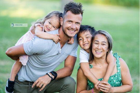 Smiling blended family together outdoors considering stepparent adoption with an adoption lawyer in Fairfax, VA.
